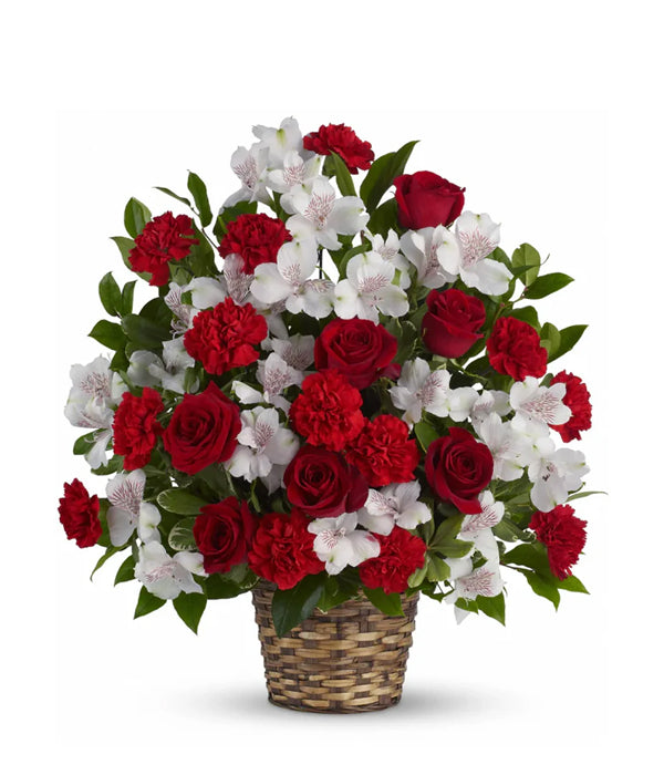 Red roses and white flowers in a basket.
