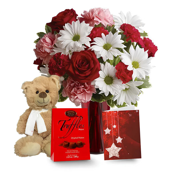 white red and pink flowers in a vase with plush toy truffles and a greeting card